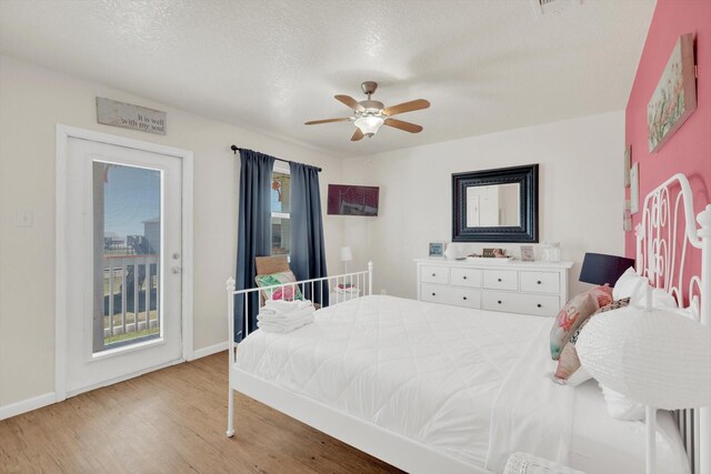 123 Howard Ave, Surfside Beach, TX 77541 - bedroom with wood finished floors, baseboards, access to exterior, a ceiling fan, and a textured ceiling