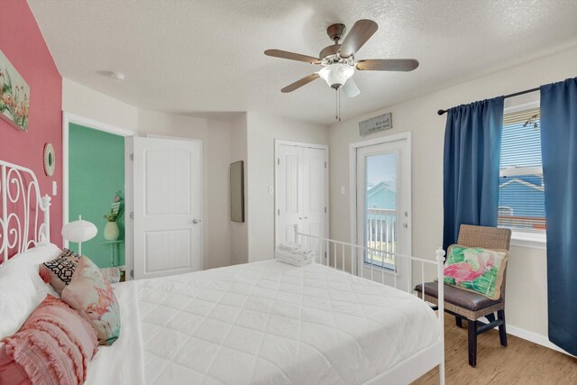 123 Howard Ave, Surfside Beach, TX 77541 - bedroom with wood finished floors, a textured ceiling, baseboards, ceiling fan, and access to exterior