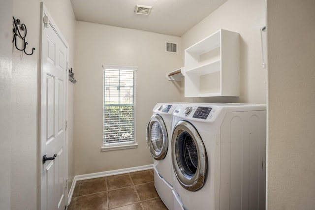 20918 Normandy Forest Dr, Spring, TX 77388 - laundry room with separate washer and dryer, dark tile patterned floors, and baseboards