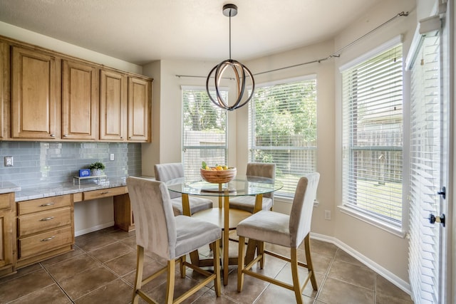 20918 Normandy Forest Dr, Spring, TX 77388 - dining area featuring plenty of natural light, dark tile patterned floors, and baseboards