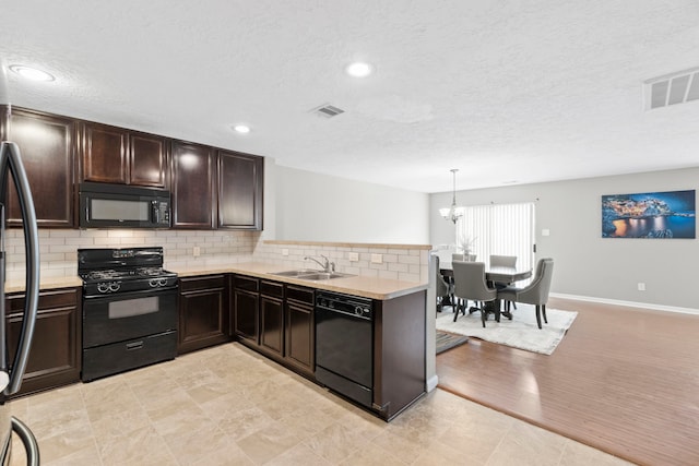 16606 Burnell Oaks Ln, Houston, TX 77090 - kitchen featuring black appliances, a sink, light countertops, a textured ceiling, and tasteful backsplash