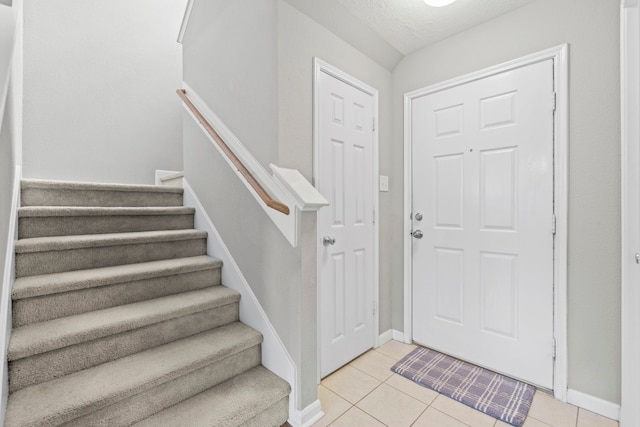 16606 Burnell Oaks Ln, Houston, TX 77090 - foyer entrance with stairs, baseboards, and light tile patterned floors