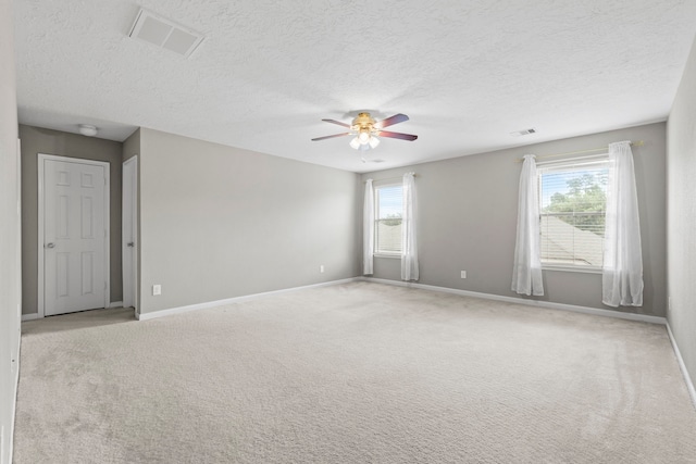 16606 Burnell Oaks Ln, Houston, TX 77090 - spare room with ceiling fan, baseboards, light carpet, a textured ceiling, and a smoke detector