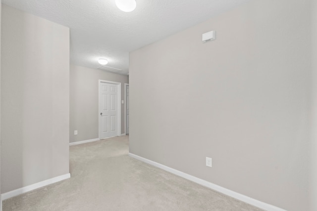 16606 Burnell Oaks Ln, Houston, TX 77090 - spare room with light colored carpet, baseboards, and a textured ceiling