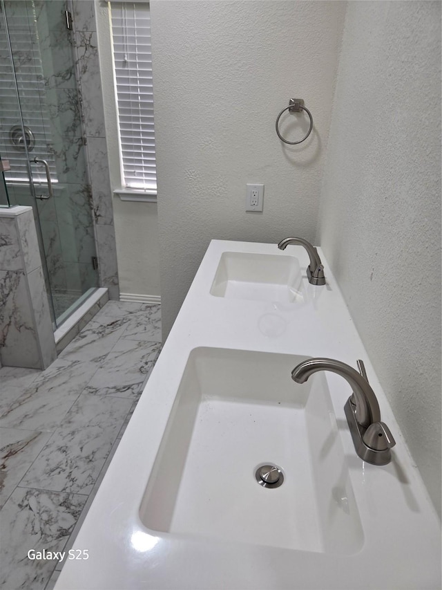 16111 Aberdeen Forest Dr, Houston, TX 77095 - full bath with a marble finish shower, marble look tile flooring, a textured wall, baseboards, and double vanity
