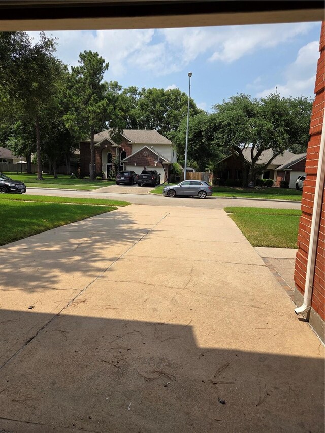 16111 Aberdeen Forest Dr, Houston, TX 77095 - view of concrete driveway with street lights
