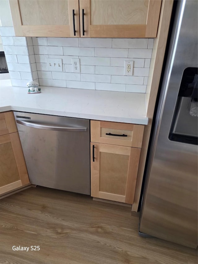 16111 Aberdeen Forest Dr, Houston, TX 77095 - kitchen featuring stainless steel appliances, light brown cabinets, and wood finished floors