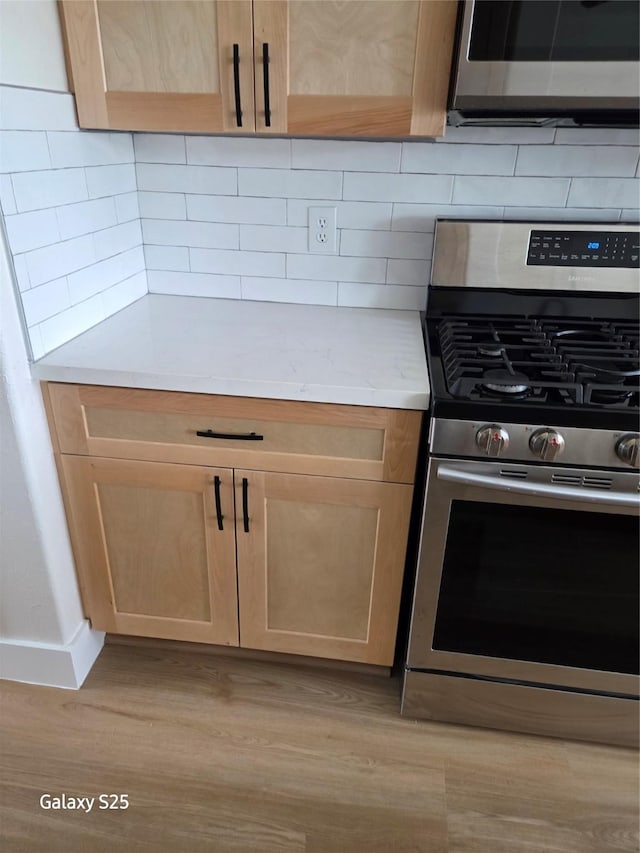 16111 Aberdeen Forest Dr, Houston, TX 77095 - kitchen with appliances with stainless steel finishes, light wood-style flooring, light countertops, and light brown cabinetry