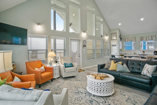 1214 Hwy 87, Gilchrist, TX 77617 - living area featuring high vaulted ceiling, light wood-type flooring, plenty of natural light, baseboards, and recessed lighting