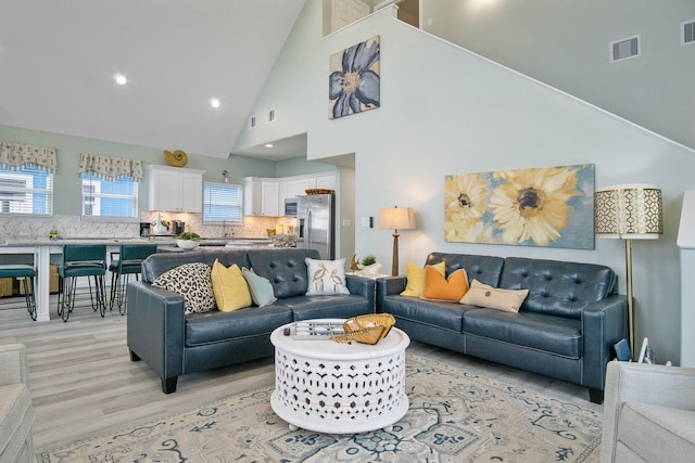 1214 Hwy 87, Gilchrist, TX 77617 - living area featuring high vaulted ceiling, light wood-style floors, and recessed lighting