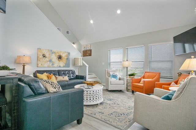 1214 Hwy 87, Gilchrist, TX 77617 - living area featuring light wood-type flooring, stairs, high vaulted ceiling, and recessed lighting