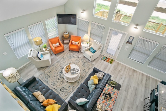 1214 Hwy 87, Gilchrist, TX 77617 - living room with wood finished floors, baseboards, and high vaulted ceiling