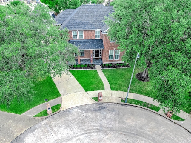 8903 Loch Lomond Ct, Houston, TX 77096 - view of front of home featuring a front lawn, brick siding, and roof with shingles