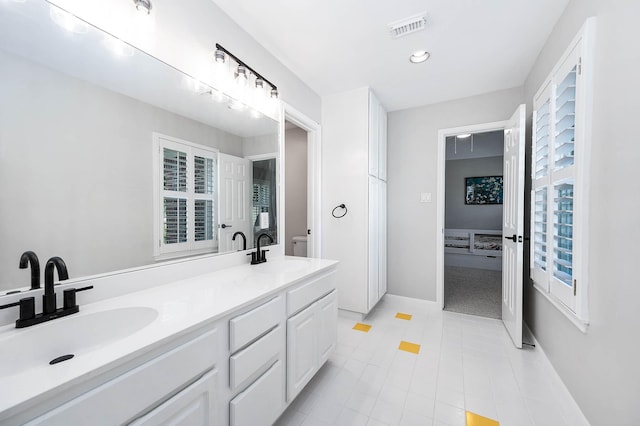 8903 Loch Lomond Ct, Houston, TX 77096 - bathroom with toilet, tile patterned floors, baseboards, double vanity, and recessed lighting