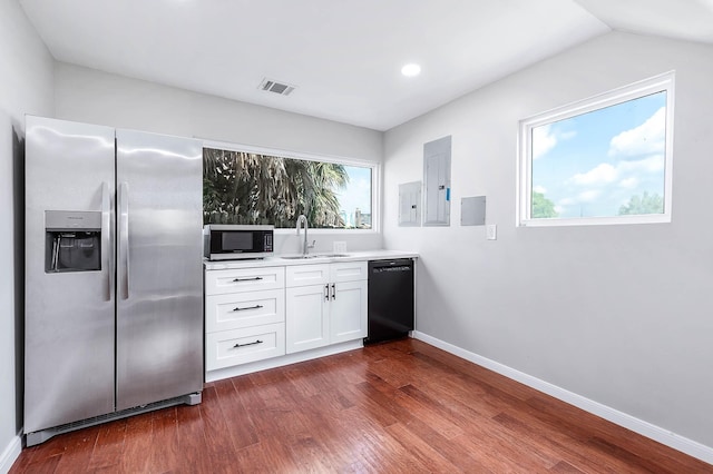 8903 Loch Lomond Ct, Houston, TX 77096 - kitchen featuring appliances with stainless steel finishes, a sink, dark wood-style flooring, white cabinetry, and baseboards