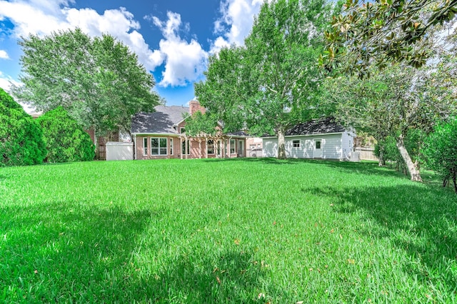 8903 Loch Lomond Ct, Houston, TX 77096 - rear view of property with a yard and a chimney