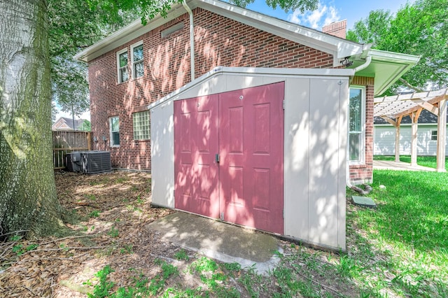 8903 Loch Lomond Ct, Houston, TX 77096 - view of shed featuring central air condition unit and a pergola