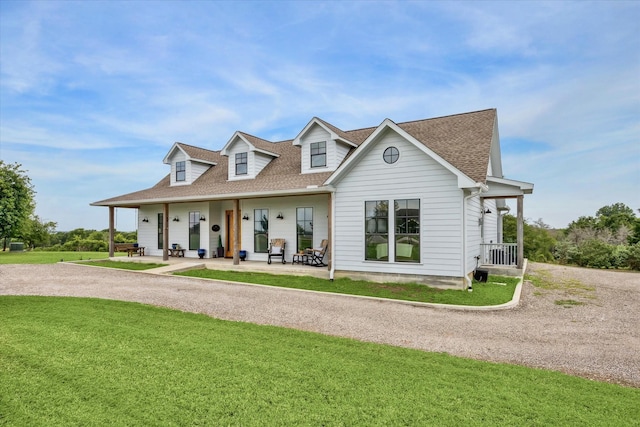 1932 Chappell Ridge Ln, Chappell Hill, TX 77426 - view of front facade with covered porch, roof with shingles, and a front yard