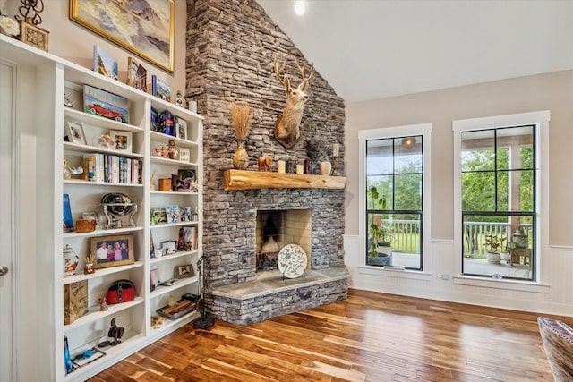 1932 Chappell Ridge Ln, Chappell Hill, TX 77426 - living area featuring wood finished floors, a wainscoted wall, lofted ceiling, and a fireplace