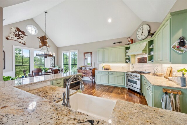 1932 Chappell Ridge Ln, Chappell Hill, TX 77426 - kitchen featuring green cabinetry, stainless steel range, open shelves, high vaulted ceiling, and backsplash