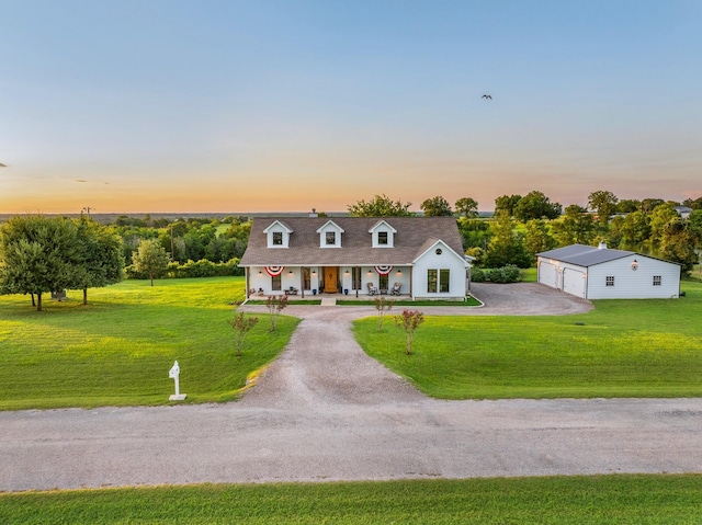 1932 Chappell Ridge Ln, Chappell Hill, TX 77426 - cape cod-style house featuring a porch, an outdoor structure, a front lawn, and a garage