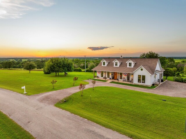 1932 Chappell Ridge Ln, Chappell Hill, TX 77426 - new england style home with covered porch, driveway, a lawn, and a garage