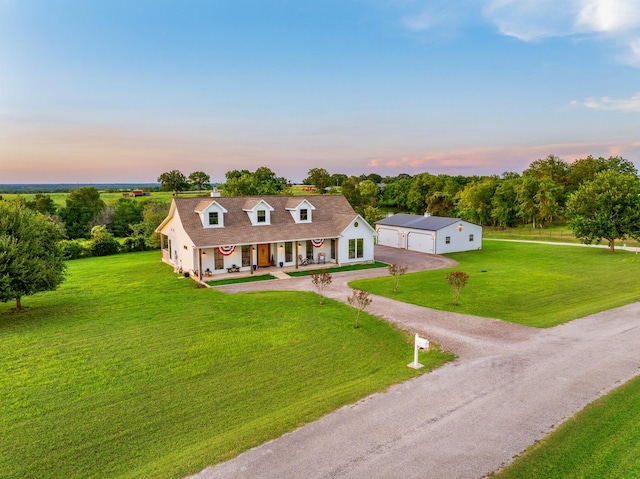 1932 Chappell Ridge Ln, Chappell Hill, TX 77426 - view of front facade with covered porch, a garage, driveway, a front lawn, and an outbuilding