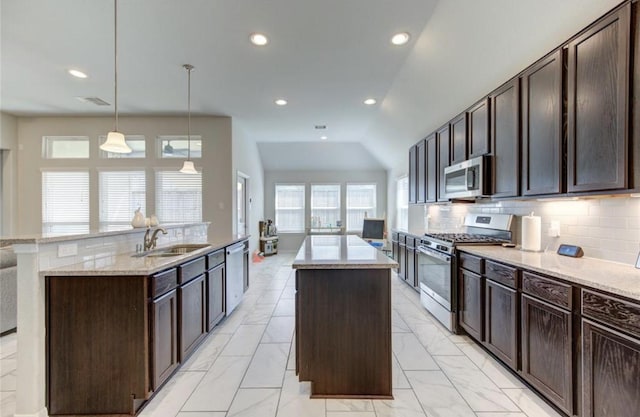 20910 Big Cypress Creek Trl, Humble, TX 77338 - kitchen featuring stainless steel appliances, a center island with sink, light marble finish flooring, dark brown cabinets, and recessed lighting