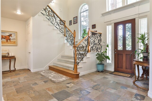 2107 N Shadow Grove Ln, Richmond, TX 77406 - foyer featuring stone tile floors, a towering ceiling, and stairway