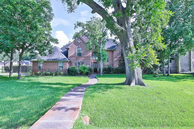 2107 N Shadow Grove Ln, Richmond, TX 77406 - traditional-style house with brick siding and a front yard