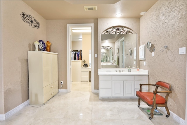 2107 N Shadow Grove Ln, Richmond, TX 77406 - full bath with a textured wall, vanity, and baseboards