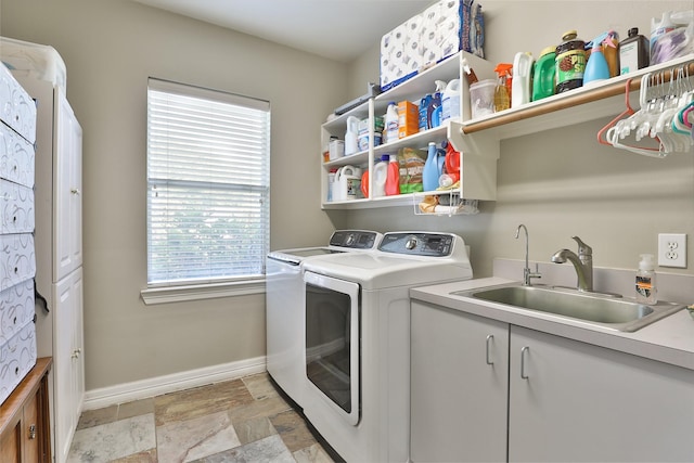 2107 N Shadow Grove Ln, Richmond, TX 77406 - laundry room featuring washing machine and clothes dryer, stone finish flooring, and cabinet space