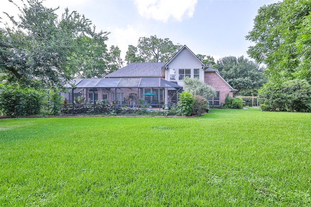 2107 N Shadow Grove Ln, Richmond, TX 77406 - rear view of property with a yard and a lanai