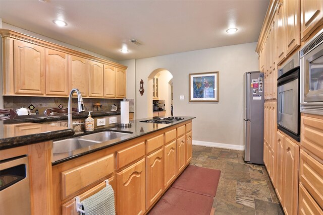 2107 N Shadow Grove Ln, Richmond, TX 77406 - kitchen featuring a sink, appliances with stainless steel finishes, stone tile flooring, baseboards, and light brown cabinets