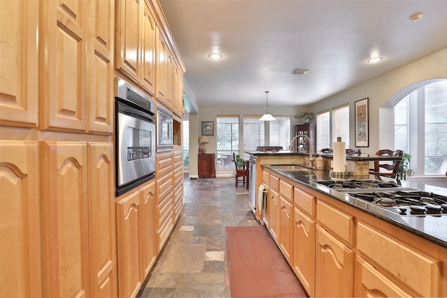 2107 N Shadow Grove Ln, Richmond, TX 77406 - kitchen featuring a sink, stone tile flooring, recessed lighting, arched walkways, and appliances with stainless steel finishes