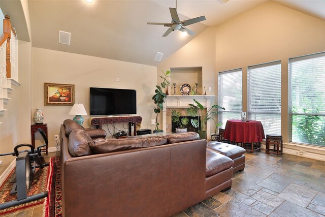 2107 N Shadow Grove Ln, Richmond, TX 77406 - living area featuring a ceiling fan, a fireplace, high vaulted ceiling, and stone tile floors