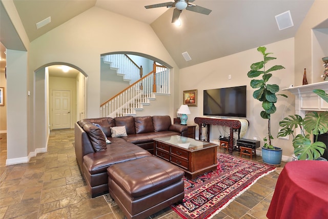 2107 N Shadow Grove Ln, Richmond, TX 77406 - living area with stone tile floors, arched walkways, ceiling fan, baseboards, and high vaulted ceiling