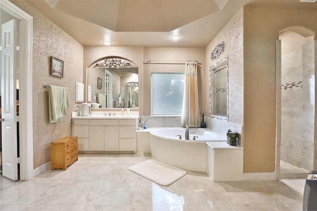 2107 N Shadow Grove Ln, Richmond, TX 77406 - full bath featuring a garden tub, vanity, a textured wall, tiled shower, and recessed lighting