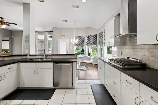 2902 Sycamore Tree Ct, Houston, TX 77345 - kitchen with stainless steel appliances, wall chimney exhaust hood, a sink, ceiling fan, and tasteful backsplash