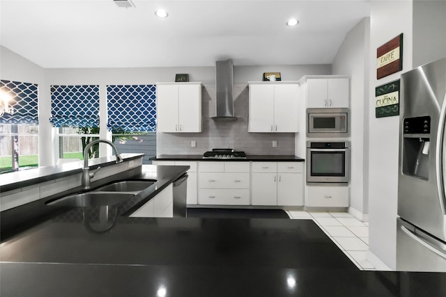 2902 Sycamore Tree Ct, Houston, TX 77345 - kitchen with appliances with stainless steel finishes, wall chimney range hood, a sink, white cabinetry, and backsplash