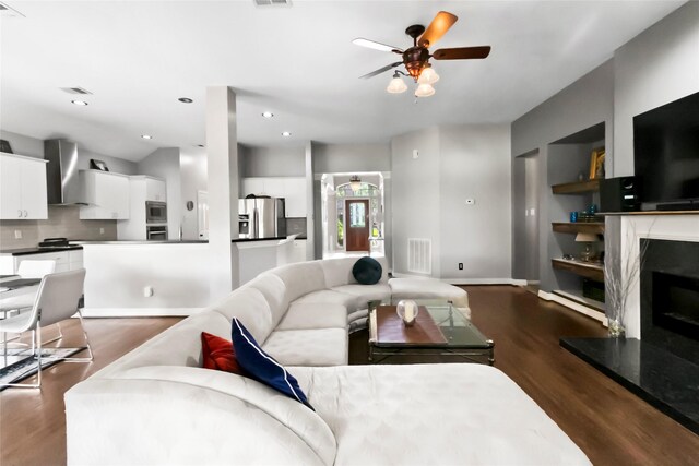 2902 Sycamore Tree Ct, Houston, TX 77345 - living room with dark wood-style floors, ceiling fan, a high end fireplace, and baseboards