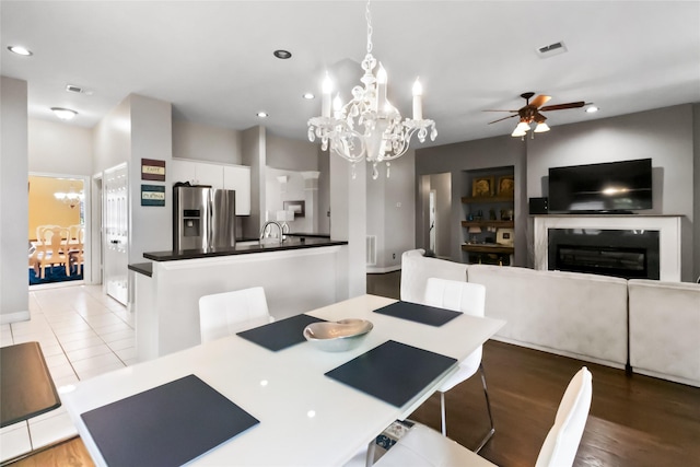 2902 Sycamore Tree Ct, Houston, TX 77345 - dining room featuring a chandelier, a glass covered fireplace, recessed lighting, ceiling fan, and baseboards