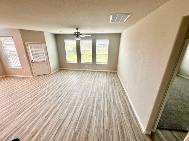 27207 Blue Pool Dr, Katy, TX 77493 - unfurnished living room featuring baseboards, wood finished floors, and a ceiling fan