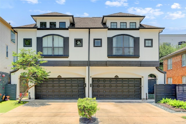 1210 Crocker St, Houston, TX 77019 - french country home featuring a garage, stucco siding, driveway, and a shingled roof