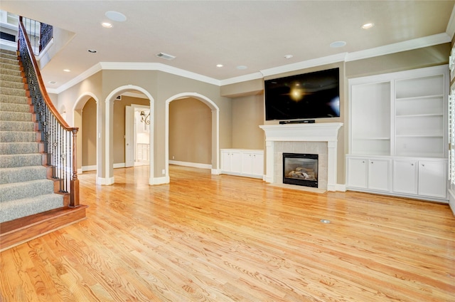 1210 Crocker St, Houston, TX 77019 - unfurnished living room with ornamental molding, light wood-style flooring, recessed lighting, stairs, and baseboards