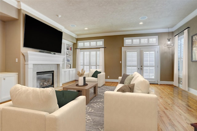 1210 Crocker St, Houston, TX 77019 - living room with wood finished floors, a textured ceiling, ornamental molding, a glass covered fireplace, and baseboards