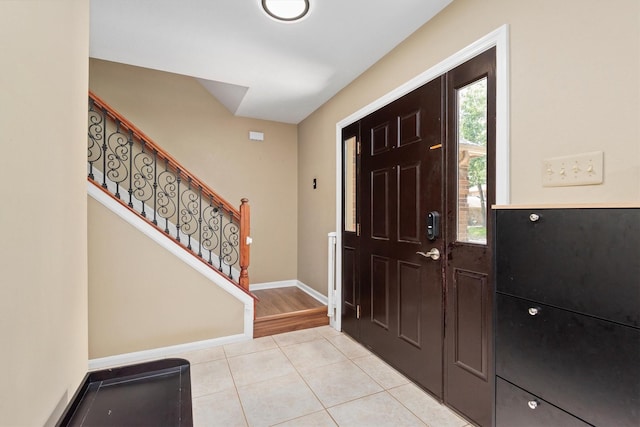 3802 Sweetgum Hill Ln, Kingwood, TX 77345 - entrance foyer with light tile patterned floors, stairway, and baseboards