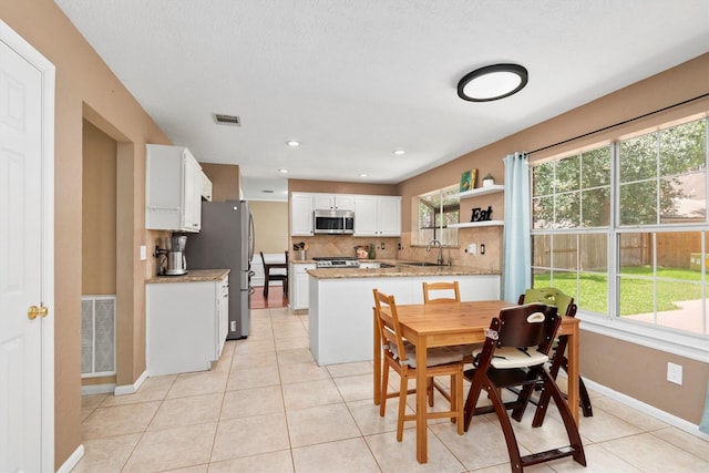 3802 Sweetgum Hill Ln, Kingwood, TX 77345 - dining area with healthy amount of natural light, baseboards, and light tile patterned floors