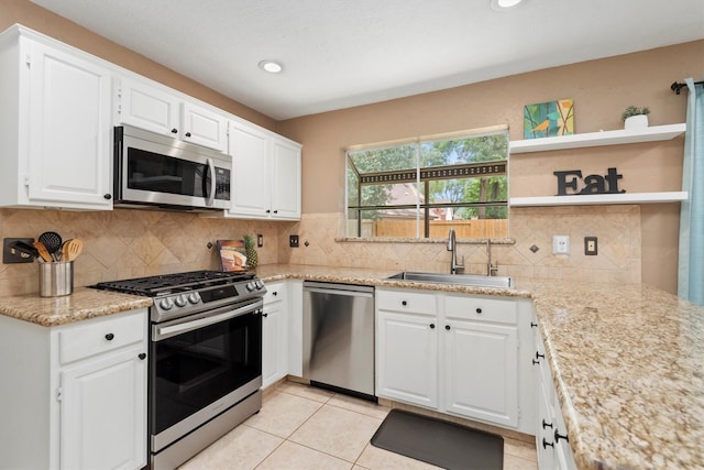 3802 Sweetgum Hill Ln, Kingwood, TX 77345 - kitchen featuring appliances with stainless steel finishes, a sink, open shelves, white cabinetry, and recessed lighting