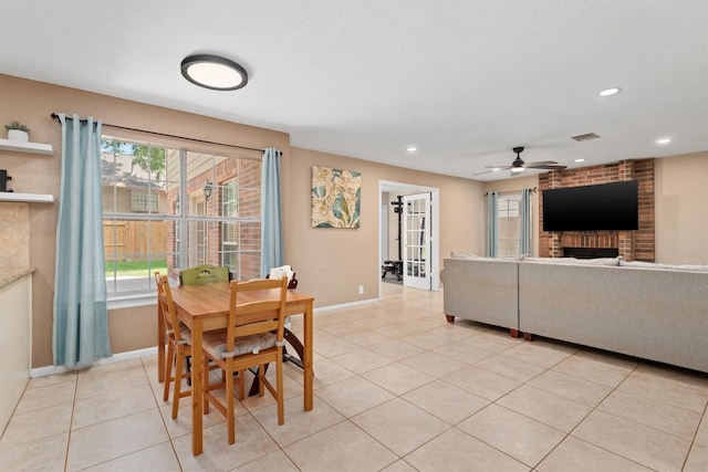 3802 Sweetgum Hill Ln, Kingwood, TX 77345 - dining area with a fireplace, baseboards, ceiling fan, light tile patterned floors, and recessed lighting